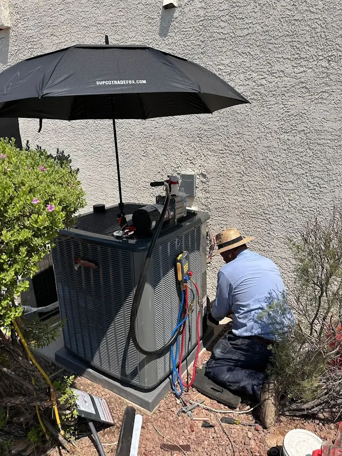 HVAC technician performing outdoor AC maintenance in Superior